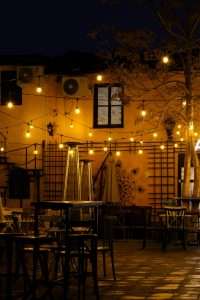 Warm patio string lights decorating modern backyard patio