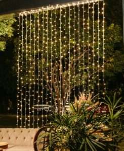 Curtain style patio string lights cascade on outdoor wall