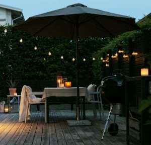 Minimalist single strand patio string lights backyard fence