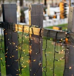 No drill patio string lights installed with outdoor adhesive hooks