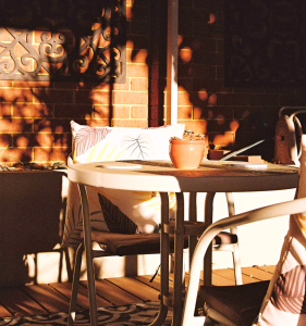 Before and after small patio makeover with budget furniture and DIY decor